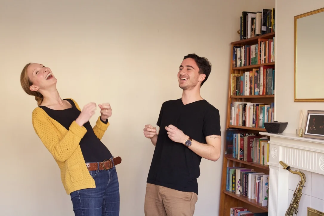 Sylvia Schmidt laughing with a student during a singing lesson