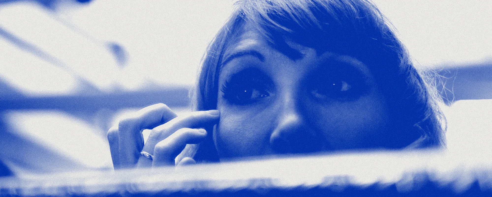 Sylvia Schmidt looking over a softly lit surface, printed in blue