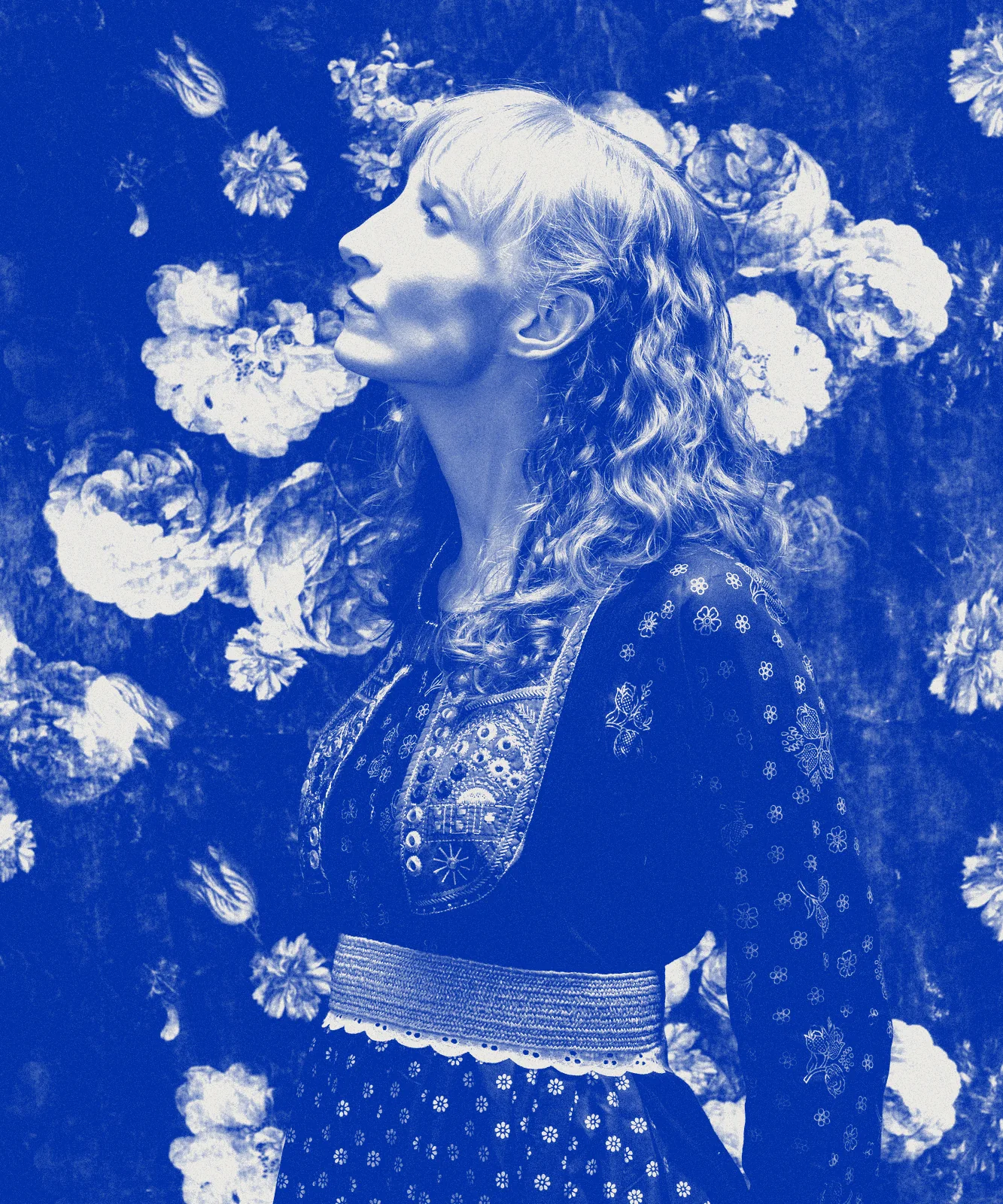 Sylvia Schmidt in profile against a floral backdrop, printed in blue