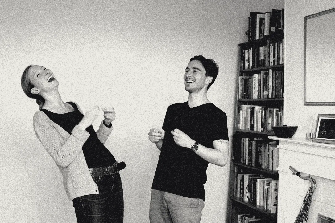 Sylvia laughing with a student during a singing lesson